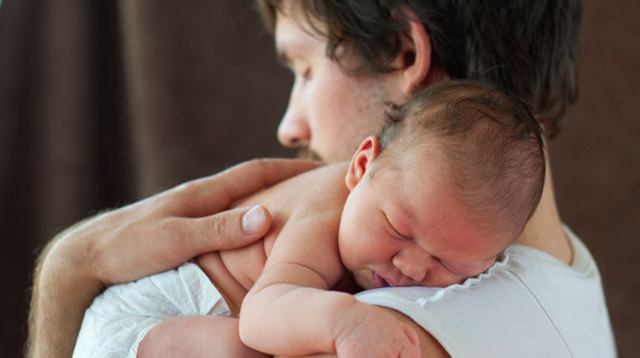 father taking care of baby