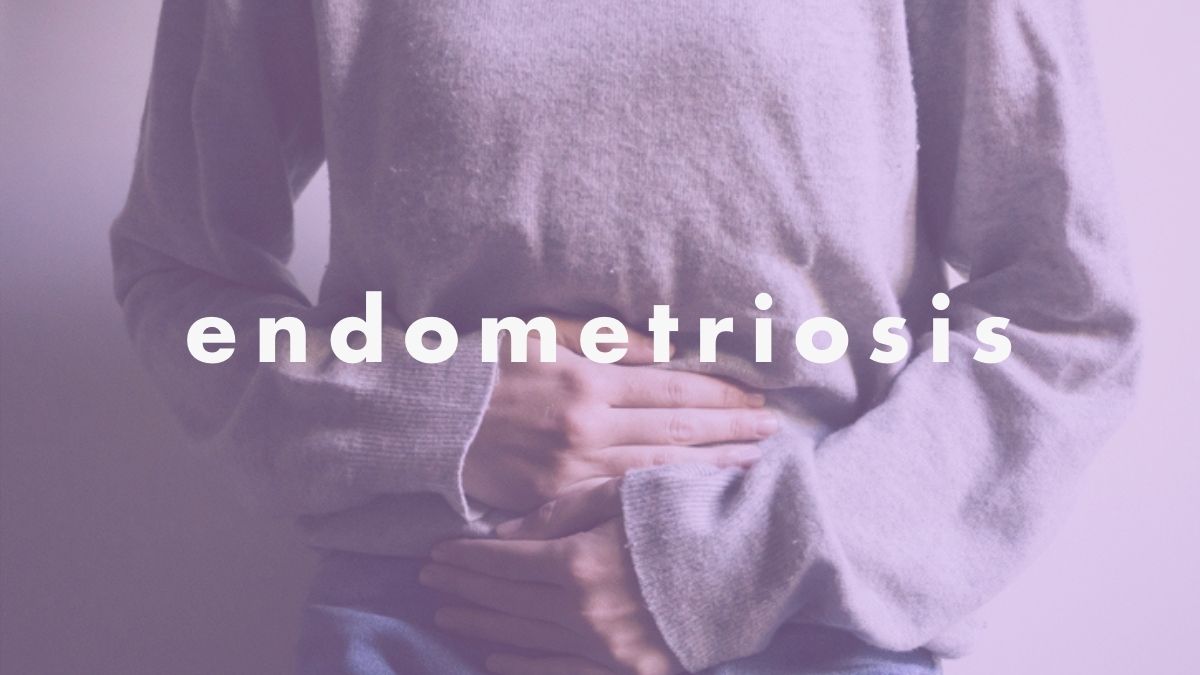 a shot of a woman's torso, with her hands over her stomach and the word endometriosis
