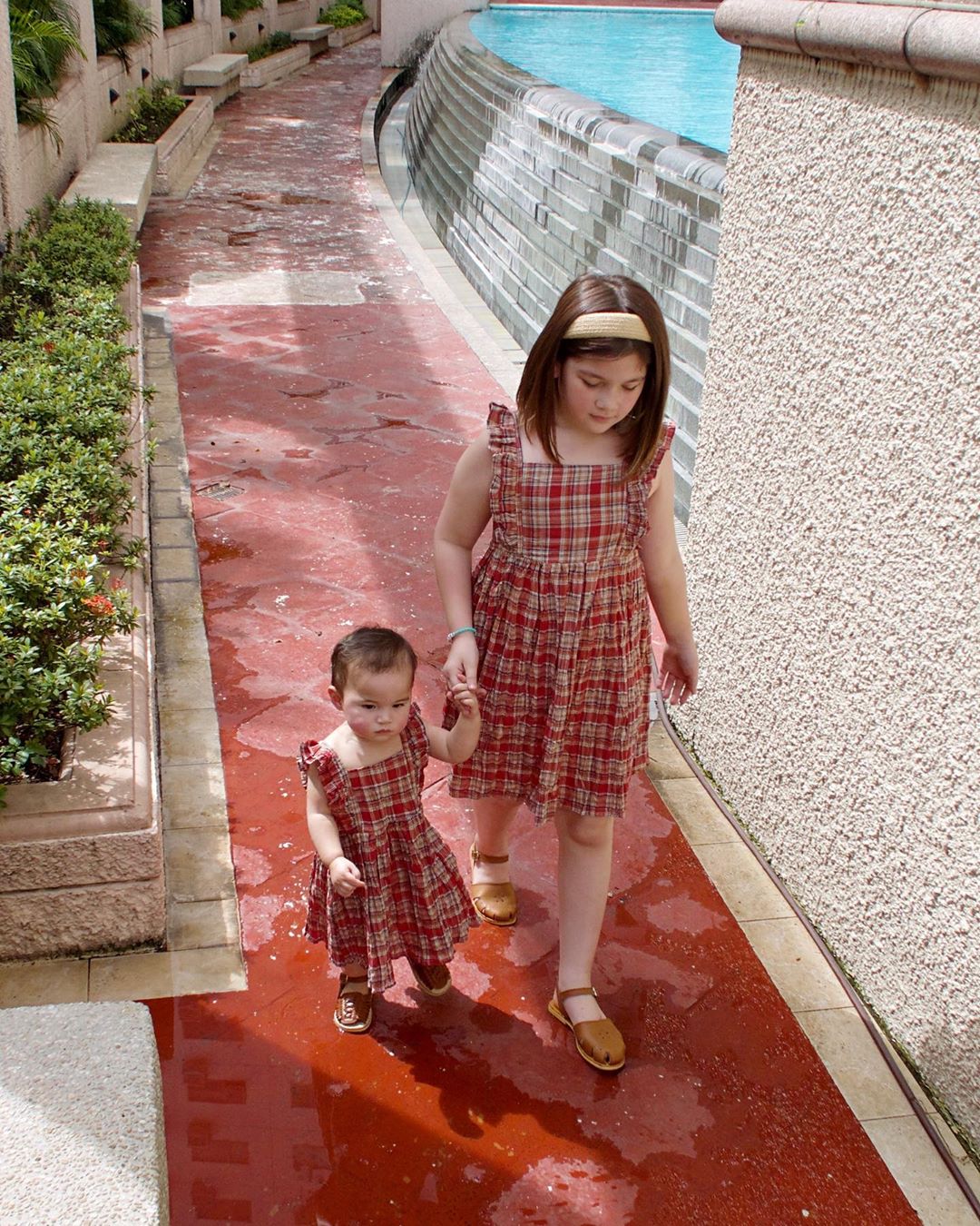 Sisters Ellie Eigenmann and Lilo Eigenmann-Alipayo in matching plaid outfits