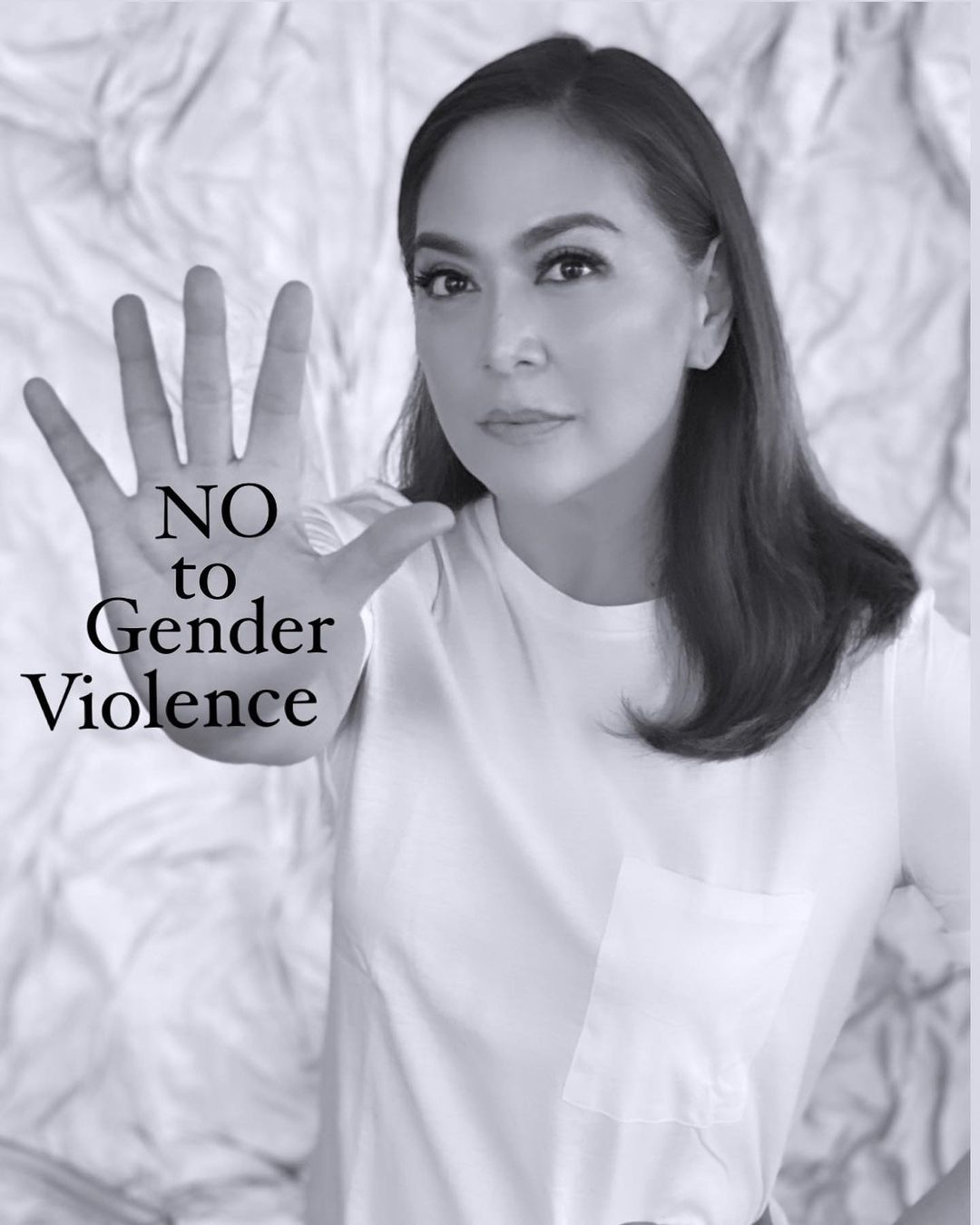 Karen Davila holding her hand up with the words NO TO GENDER VIOLENCE