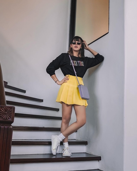 Patricia Prieto wearing a black top and yellow skirt