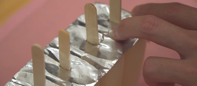 Chocolate-dipped ice cream recipe: Cover with aluminum foil and poke tiny holes where the popsicle sticks would go in.