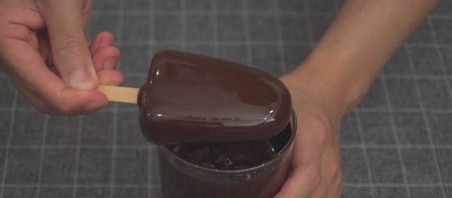 Chocolate-dipped ice cream recipe: Dip the popsicle in the melted chocolate.