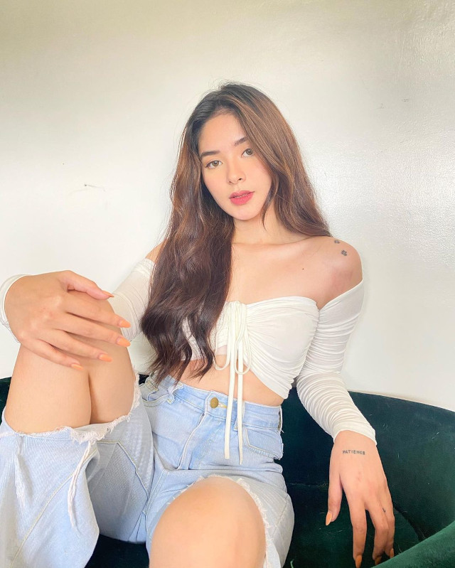 Loisa Andalio wearing a white off-shoulder top and ripped jeans