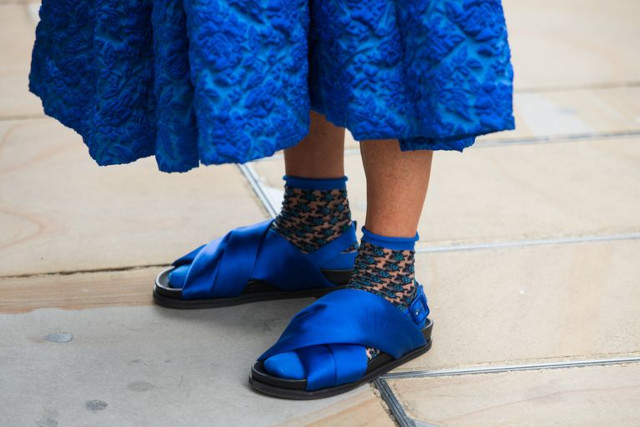 Woman wearing blue socks and sandals