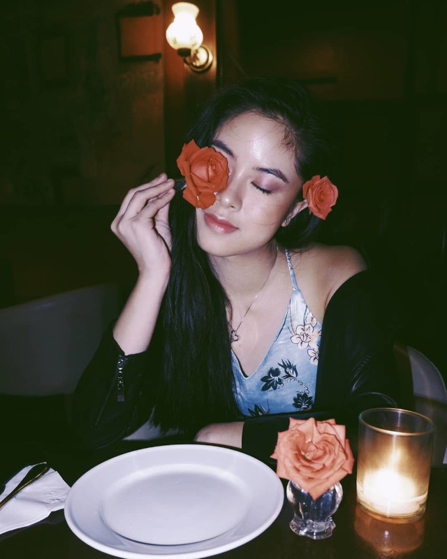 Kisses Delavin posing with flowers