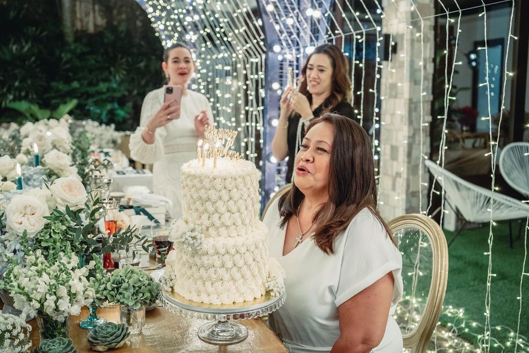 Bea's mom blew the candles of her two-tiered cake