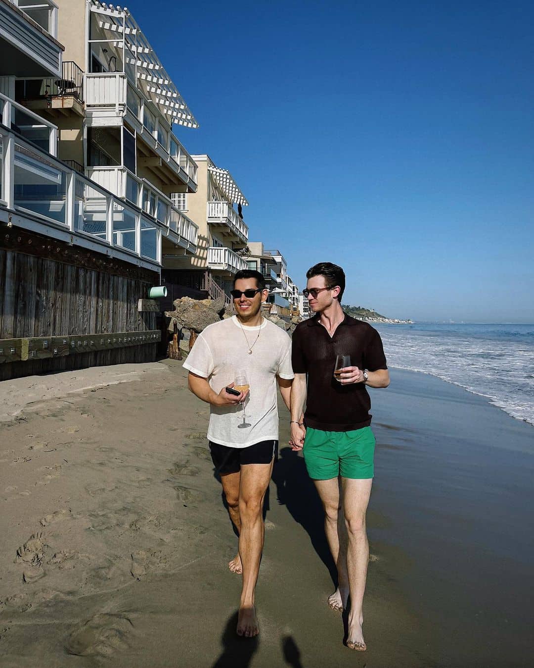 Raymond Gutierrez walks on the beach with his boyfriend Rob William