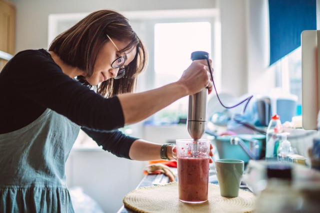 woman making a smoothie
