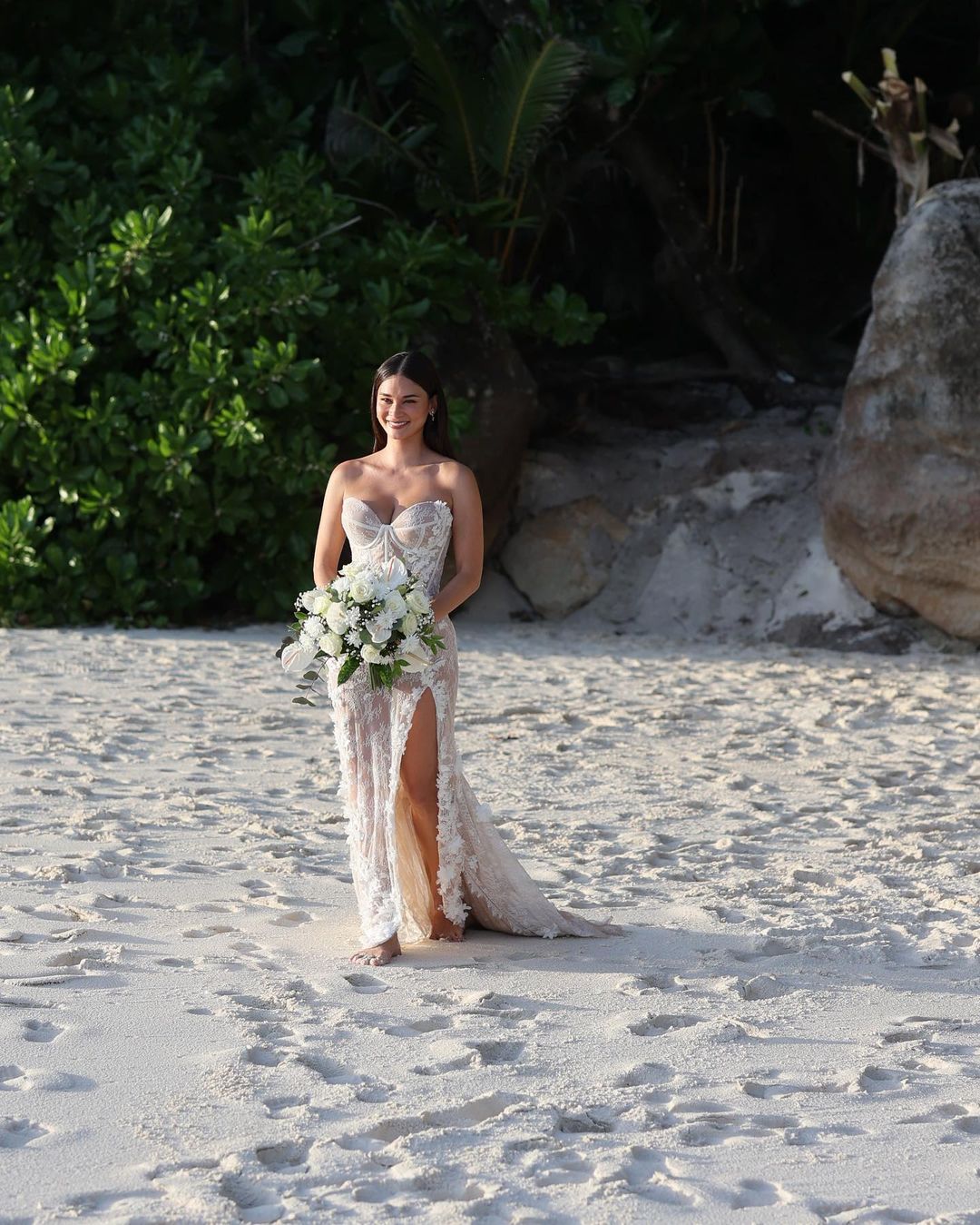 Pia Wurtzbach in her wedding gown walking down the beach at North Island, Seychelles