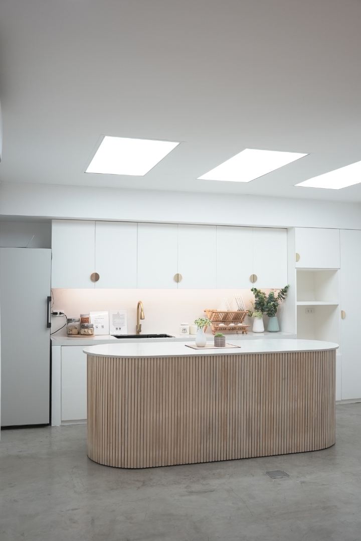A kitchen area that reflects Scandinavian interior design (all white and light-colored wood).