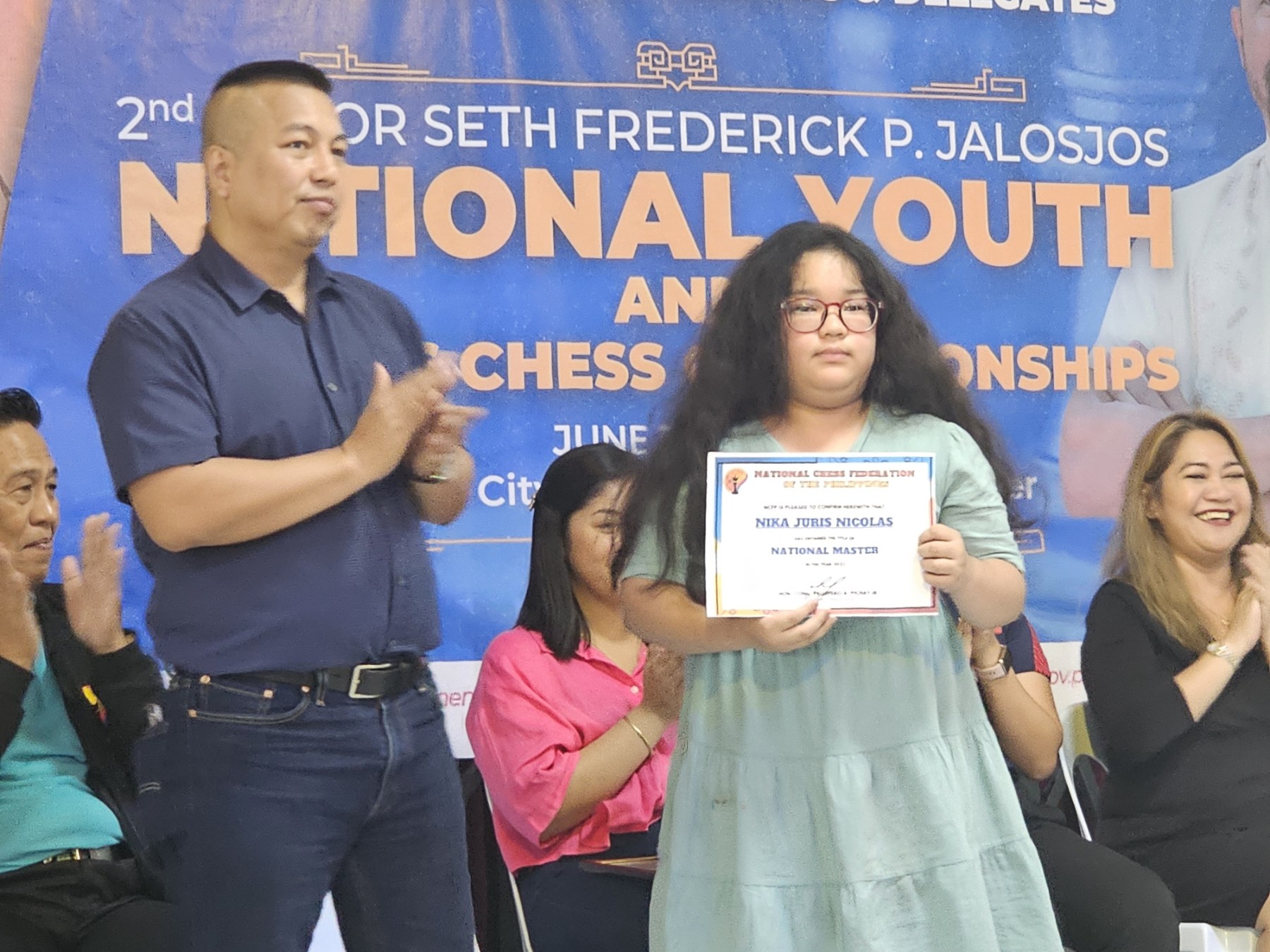Grandmaster Jayson Gonzales, Chief Executive Officer of the National Chess Federation of the Philippines, with National Master Nika Juris Nicolas