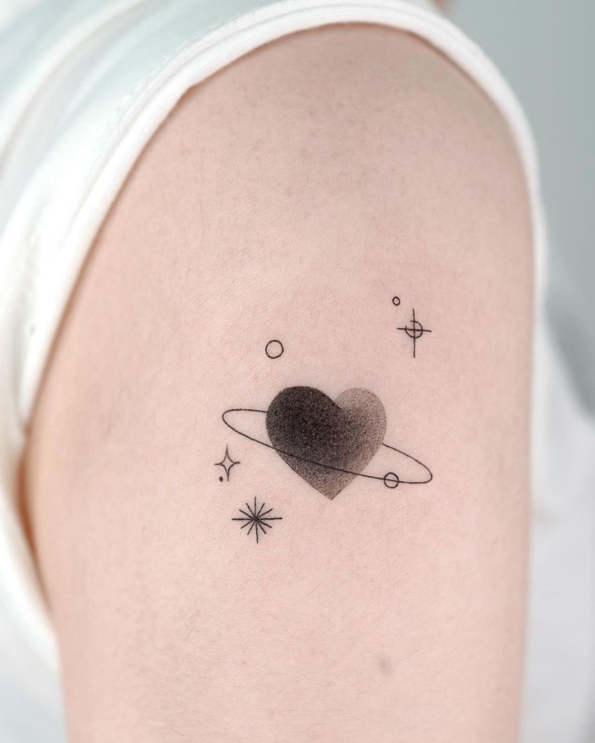 Minimalistic style Jupiter planet symbol tattooed on