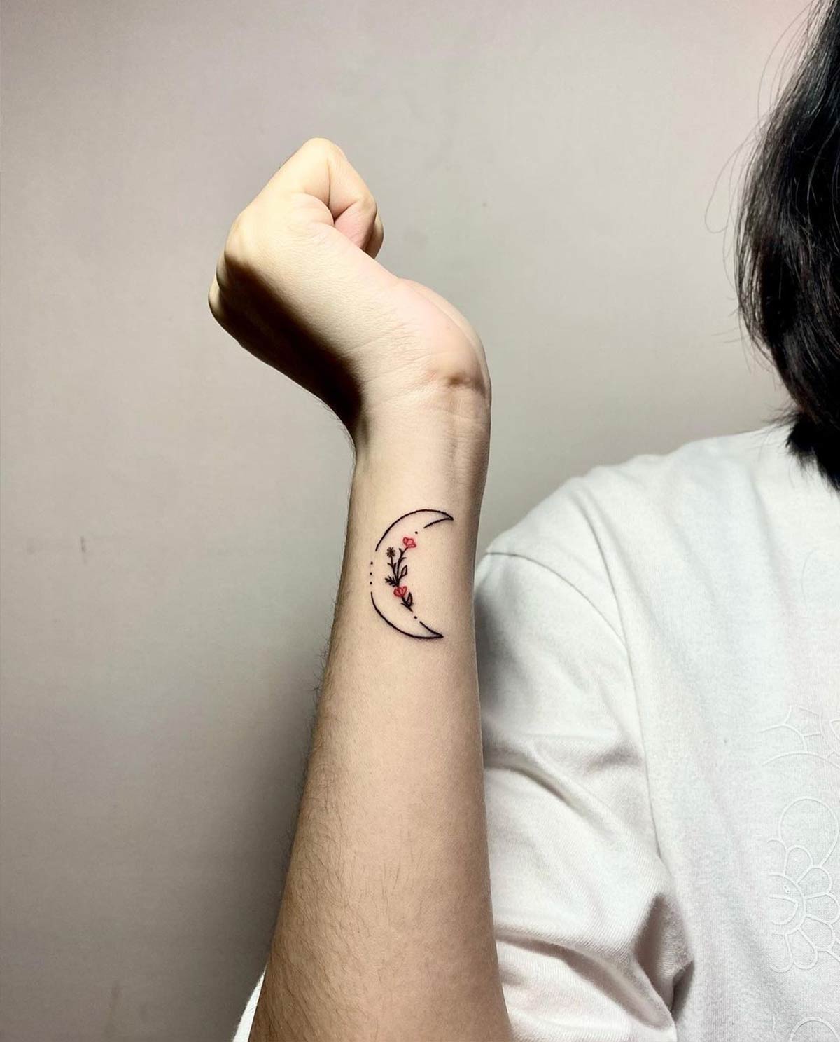 Small moon tattoo on the right wrist