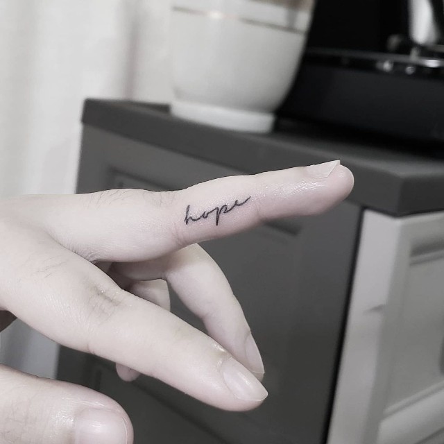 small tattoo on hand with meaning