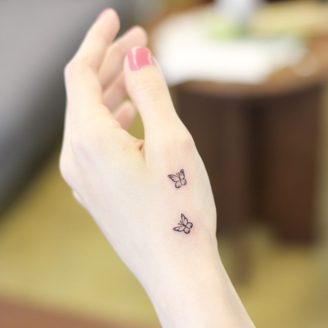 small tattoo on hand with meaning