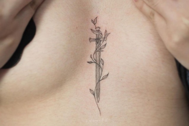 Sword tattoo on sternum