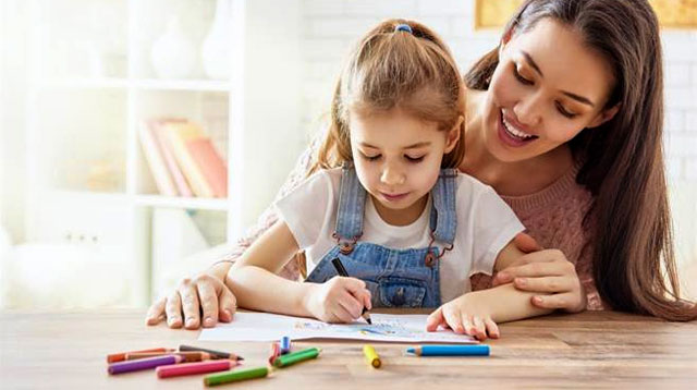 Enhancing Cognitive Growth in Children. A Mother helps her child in learning writing