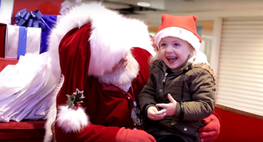 Santa signs with little girl