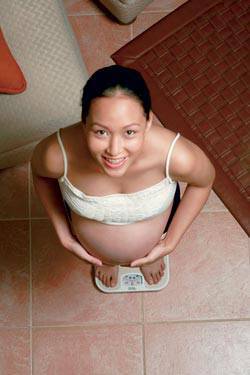 pregnant woman on weighing scale