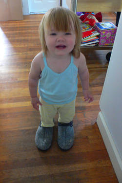 kid wearing big shoes