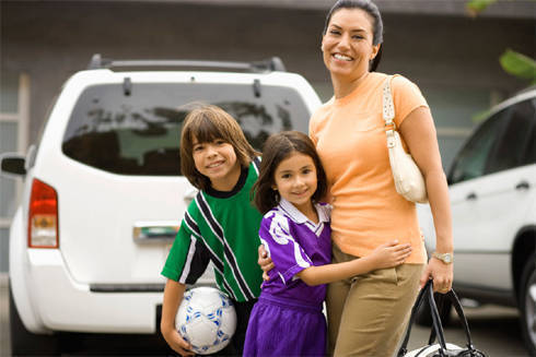 mom and kids with car