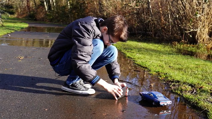autistic boy taking realistic photos of toy cars