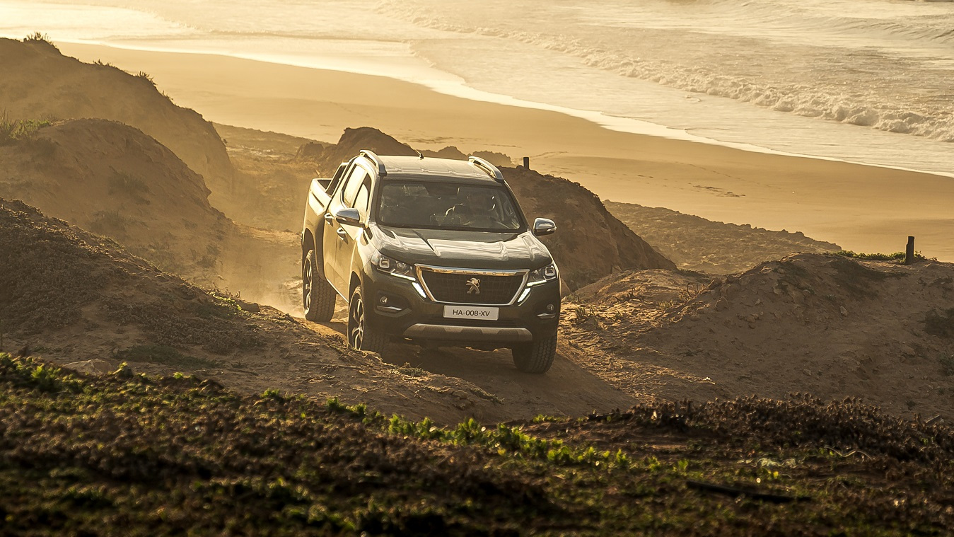 The Peugeot Landtrek going up a hill by the sea
