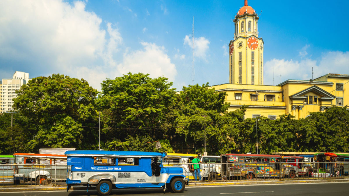 Manila City Hall with jeepneys lined up at a terminal