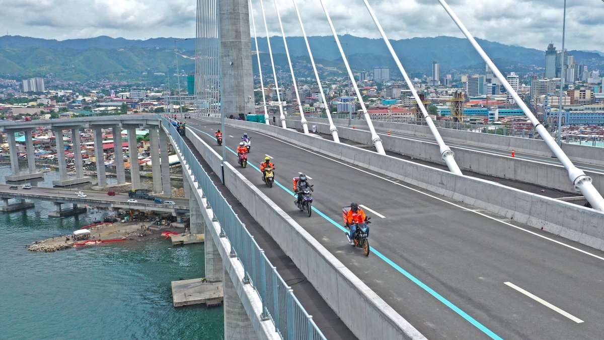 Small motorcycles cross the Cebu-Cordova Link Expressway in Cebu City