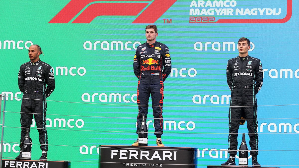 Red Bull Racing driver Max Verstappen celebrates his win at the 2022 Hungarian Grand Prix podium with second placer Lewis Hamilton and third placer George Russell