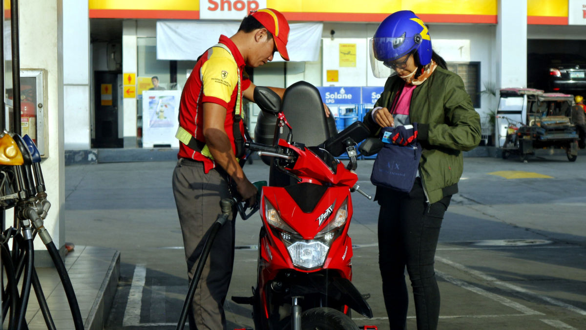 A motorcycle being refueled at a Shell station in Metro Manila