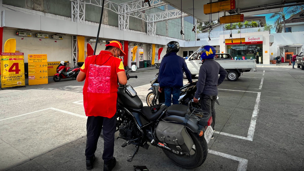 motorcycle refueling at a gas station