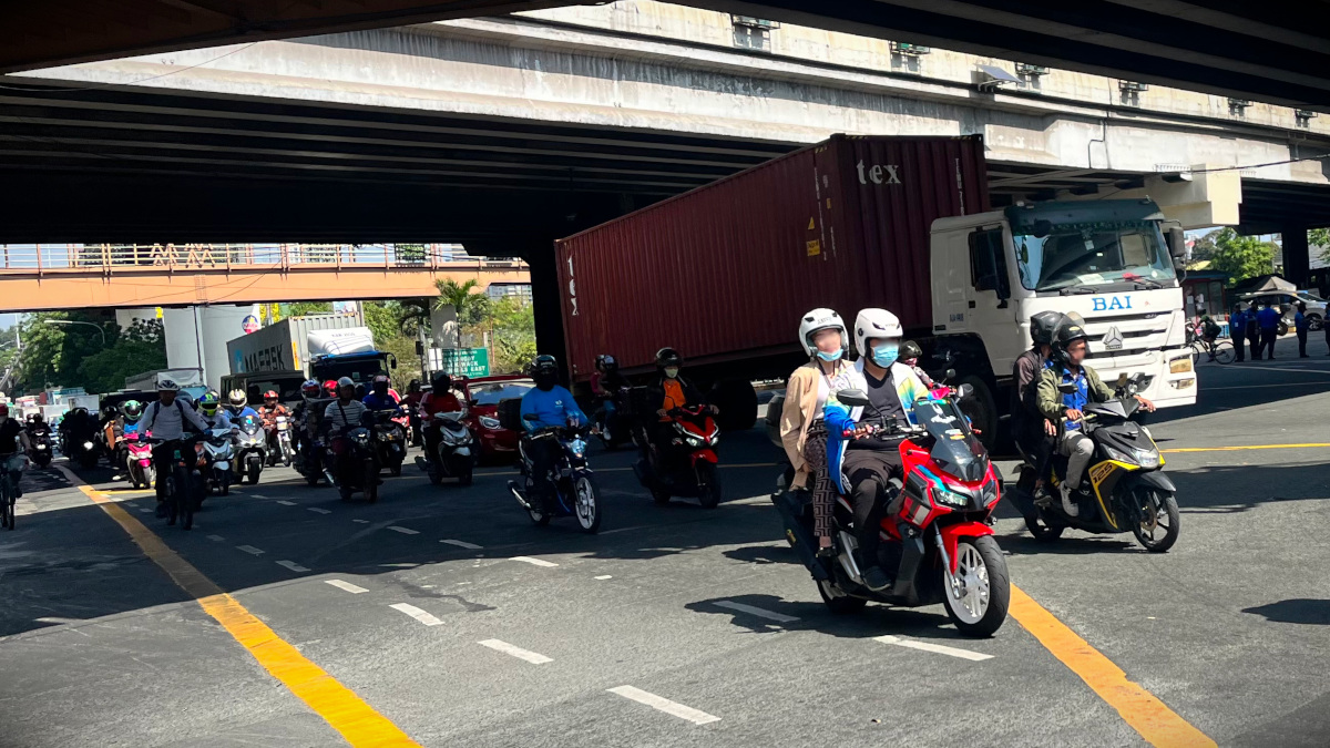 motorcycles and other vehicles at an intersection in metro manila