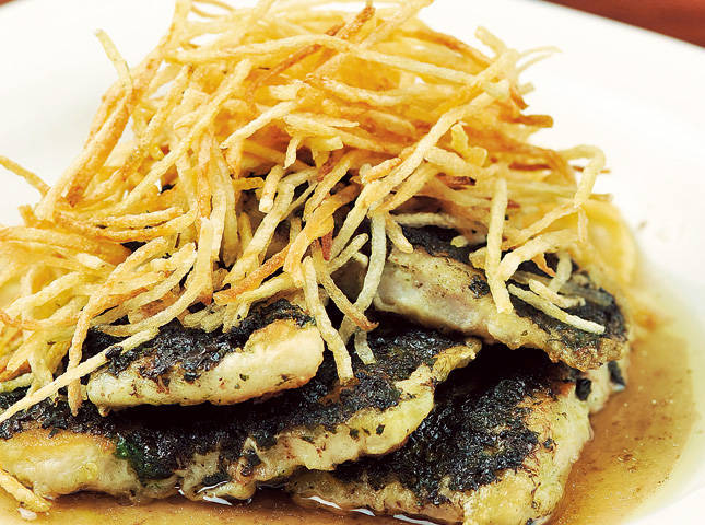 pan-fried cream dory stacked with pesto in between, topped with crispy potato sticks