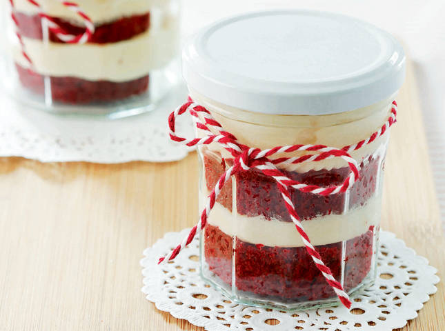 red velvet cupcake trifles in a dainty jar on a doily