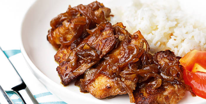 fish cooked bistek tagalog style, topped with caramelized onions and served with rice