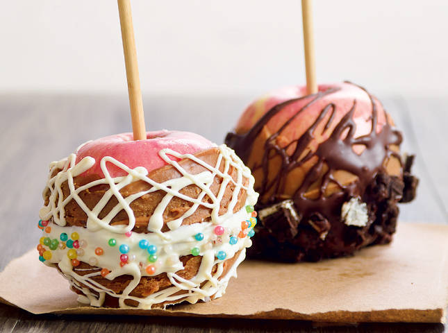 caramel and candy coated apples on a stick