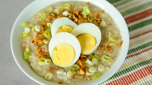 lugaw topped with toasted garlic, chopped onions, and egg