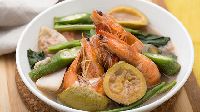 shrimp sinigang with bayabas or guava, okra, sitaw, and kangkon in a big white bowl