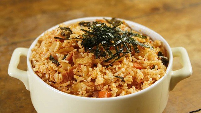 kimchi fried rice topped with nori strips in a bowl