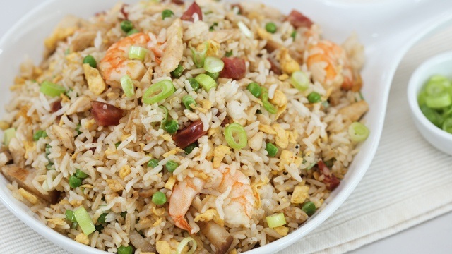 Yang Chow fried rice with shrimps, chorizo bits, and scallionso on a serving plate