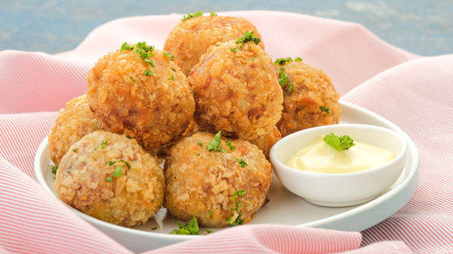 corned beef balls piled up on a plate 