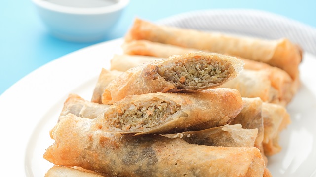 beef lumpia filled with sweet potato or camote, piled on a white plate