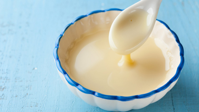 Sweetened condensed milk in a bowl. Can be used to make maja blanca without coconut milk.