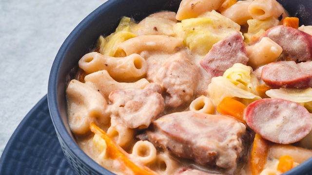 close up of creamy sopas with macaroni, chopped chicken, sliced hot dogs, and carrots