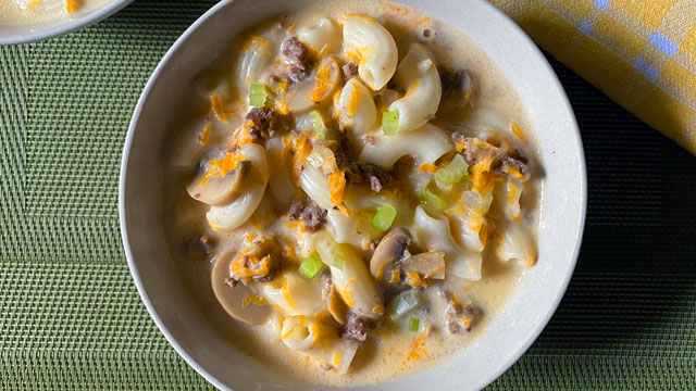 sopas with beef and mushroom topped with cheese, in a bowl