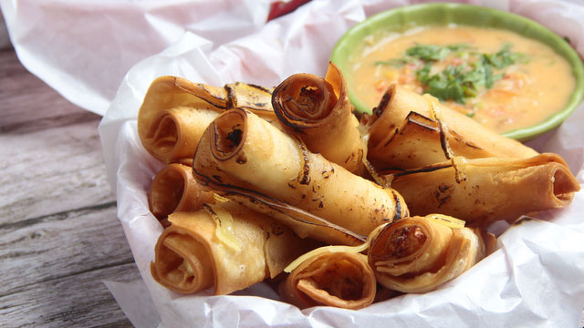 lumpia served in a basket with dip