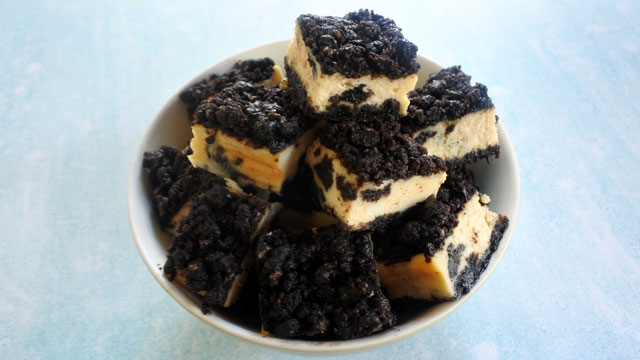 oreo cheesecake cubes stacked in a bowl