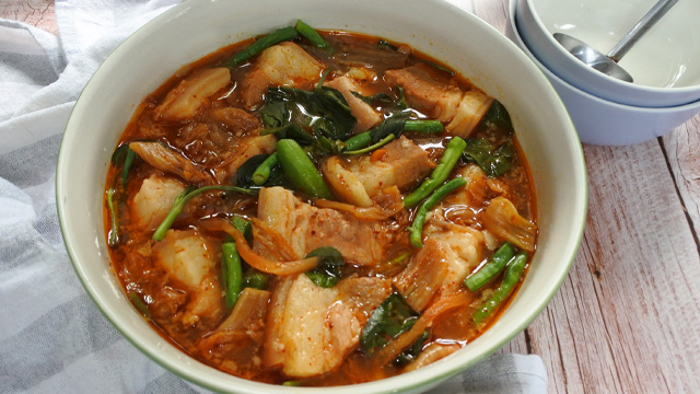 kimchi pork sinigang in a big white serving bowl